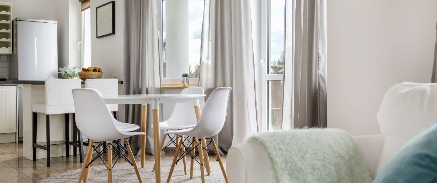 63502531 - new flat with round table, white chairs and open kitchen